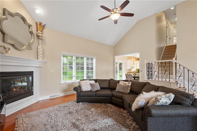 8007 Pressley Ct, Mccandless, PA 15237 - living room with a ceiling fan, wood finished floors, high vaulted ceiling, a glass covered fireplace, and recessed lighting