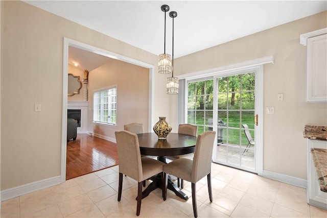 8007 Pressley Ct, Mccandless, PA 15237 - dining room featuring baseboards, a glass covered fireplace, and light tile patterned floors