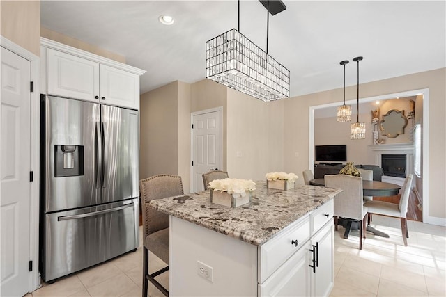 8007 Pressley Ct, Mccandless, PA 15237 - kitchen featuring stainless steel refrigerator with ice dispenser, light tile patterned floors, white cabinetry, a kitchen island, and light stone countertops