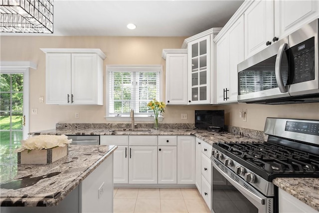 8007 Pressley Ct, Mccandless, PA 15237 - kitchen with appliances with stainless steel finishes, a sink, white cabinets, light tile patterned floors, and light stone counters