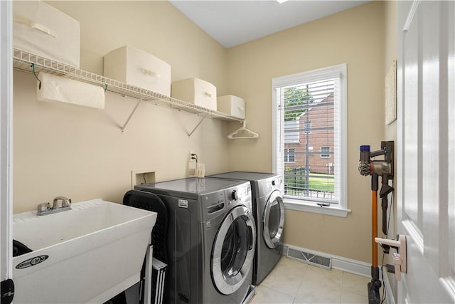 8007 Pressley Ct, Mccandless, PA 15237 - washroom with washing machine and dryer, baseboards, plenty of natural light, and light tile patterned floors