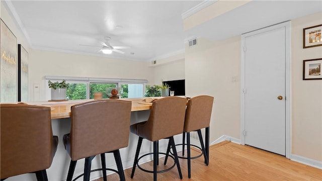 718 Carriage Cir, Pennsbury, PA 15205 - dining space with light wood-style flooring, crown molding, ceiling fan, and baseboards