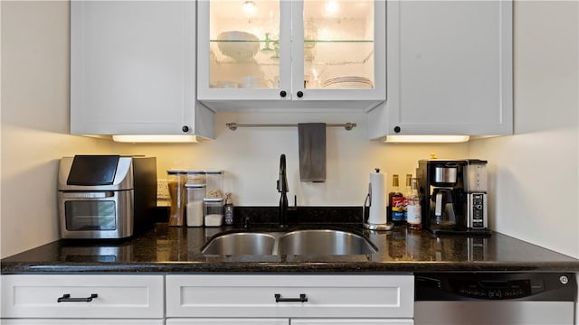 718 Carriage Cir, Pennsbury, PA 15205 - kitchen featuring stainless steel dishwasher, a sink, white cabinets, glass insert cabinets, and dark stone countertops