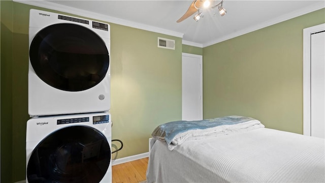 718 Carriage Cir, Pennsbury, PA 15205 - bedroom featuring stacked washer / dryer, wood finished floors, crown molding, baseboards, and ceiling fan