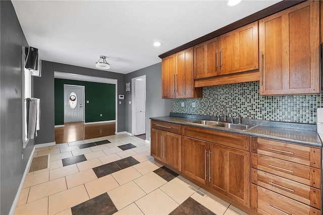2001 Potomac Ave, Banksville/Westwood, PA 15216 - kitchen with a sink, baseboards, dark countertops, brown cabinetry, and recessed lighting