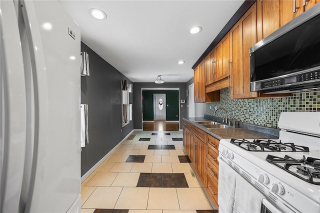 2001 Potomac Ave, Banksville/Westwood, PA 15216 - kitchen featuring white appliances, a sink, brown cabinetry, dark countertops, and recessed lighting