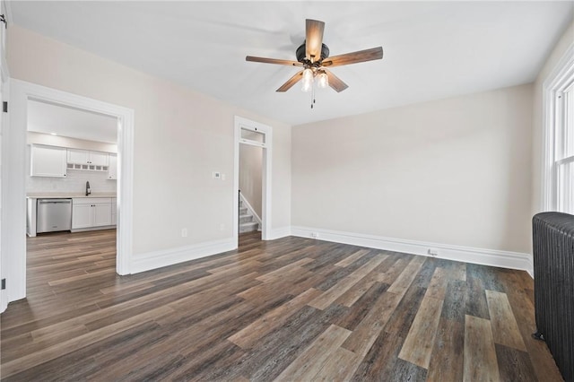 130 Pearl St, Bloomfield, PA 15224 - unfurnished living room featuring radiator heating unit, a ceiling fan, dark wood-style flooring, and baseboards