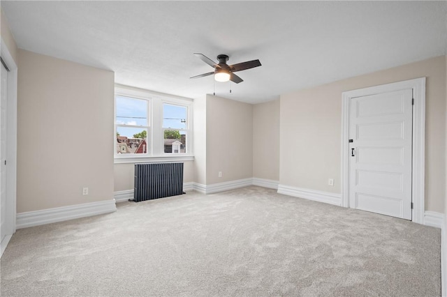 130 Pearl St, Bloomfield, PA 15224 - unfurnished living room featuring ceiling fan, carpet flooring, baseboards, and radiator heating unit