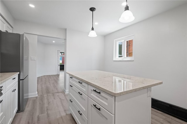 130 Pearl St, Bloomfield, PA 15224 - kitchen featuring freestanding refrigerator, light wood finished floors, a center island, white cabinetry, and recessed lighting