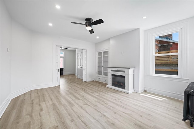 130 Pearl St, Bloomfield, PA 15224 - unfurnished living room with ceiling fan, light wood-type flooring, baseboards, recessed lighting, and radiator heating unit