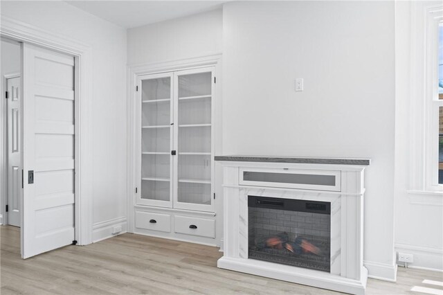 130 Pearl St, Bloomfield, PA 15224 - unfurnished living room with wood finished floors, a fireplace, and baseboards