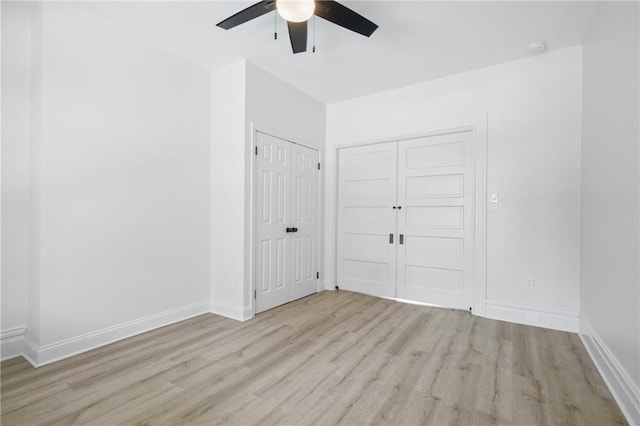 130 Pearl St, Bloomfield, PA 15224 - unfurnished bedroom with light wood-style flooring, baseboards, and ceiling fan