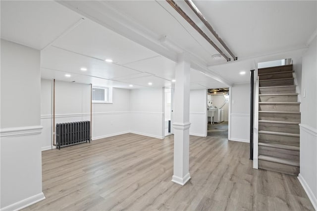 130 Pearl St, Bloomfield, PA 15224 - basement with radiator, stairway, wood finished floors, recessed lighting, and baseboards