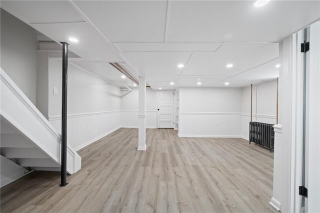130 Pearl St, Bloomfield, PA 15224 - finished below grade area featuring wood finished floors, radiator heating unit, baseboards, and recessed lighting