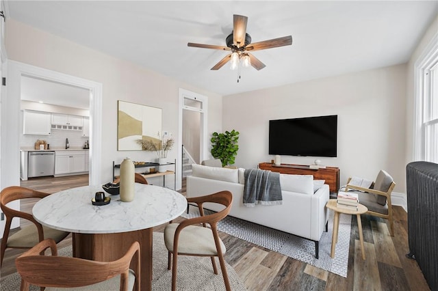 130 Pearl St, Bloomfield, PA 15224 - dining area featuring ceiling fan, wood finished floors, and radiator