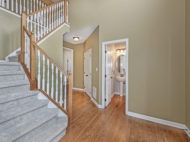 430 Longleaf Dr, Peters Twp, PA 15367 - stairway featuring a high ceiling, baseboards, and wood finished floors