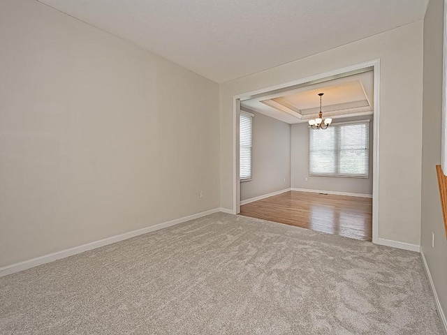 430 Longleaf Dr, Peters Twp, PA 15367 - carpeted spare room with a chandelier, a raised ceiling, and baseboards