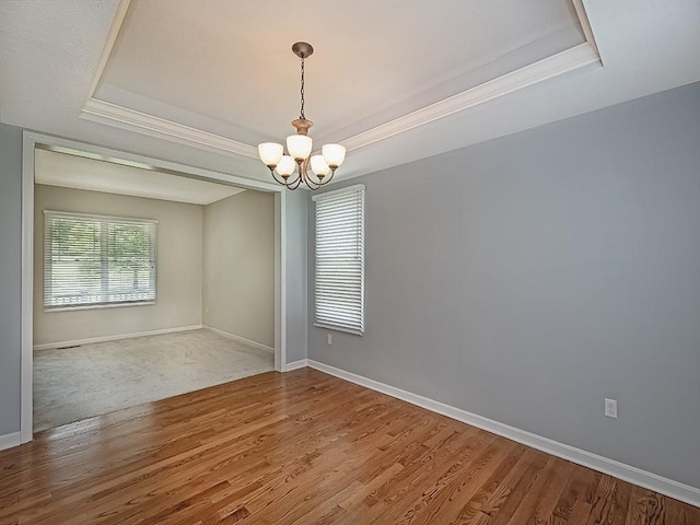 430 Longleaf Dr, Peters Twp, PA 15367 - spare room with a raised ceiling, a chandelier, wood finished floors, baseboards, and ornamental molding