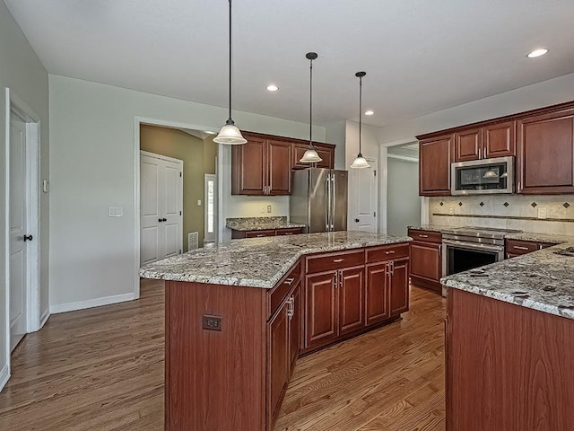 430 Longleaf Dr, Peters Twp, PA 15367 - kitchen featuring stainless steel appliances, dark wood finished floors, a kitchen island, baseboards, and pendant lighting
