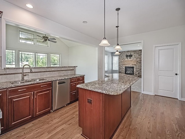 430 Longleaf Dr, Peters Twp, PA 15367 - kitchen featuring stainless steel dishwasher, a sink, light wood-type flooring, ceiling fan, and a stone fireplace