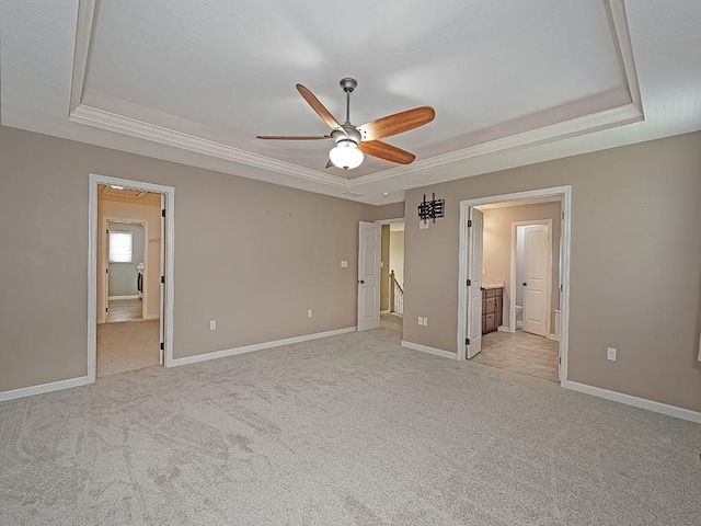430 Longleaf Dr, Peters Twp, PA 15367 - unfurnished bedroom featuring a tray ceiling, light colored carpet, ensuite bathroom, baseboards, and ornamental molding