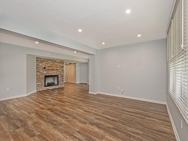 430 Longleaf Dr, Peters Twp, PA 15367 - unfurnished living room featuring baseboards, recessed lighting, wood finished floors, and a stone fireplace