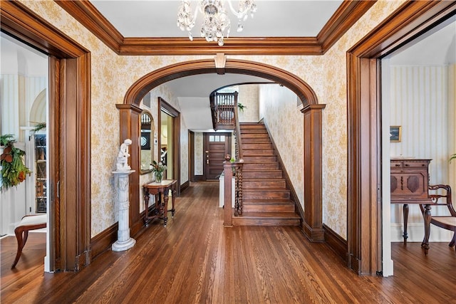 700 Meade St, Monongahela, PA 15063 - hallway featuring wallpapered walls, dark wood-type flooring, a chandelier, arched walkways, and crown molding