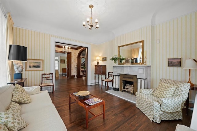 700 Meade St, Monongahela, PA 15063 - living area with a chandelier, wallpapered walls, wood finished floors, a fireplace with raised hearth, and baseboards