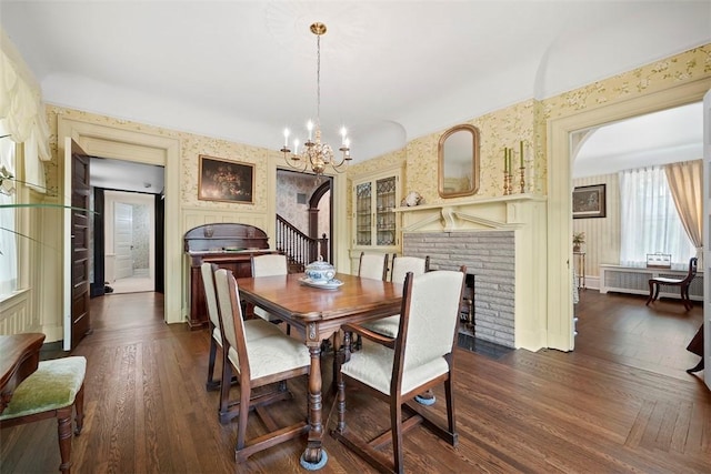 700 Meade St, Monongahela, PA 15063 - dining area featuring arched walkways, a fireplace, a chandelier, and dark wood-type flooring