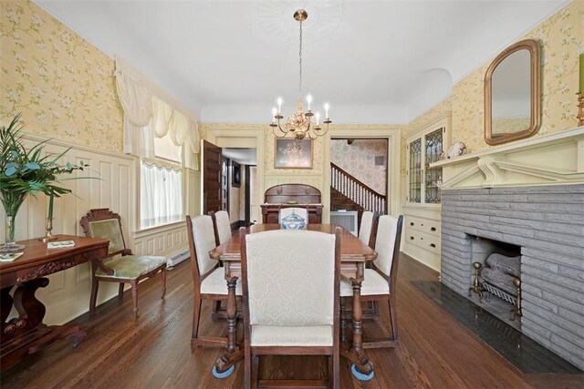 700 Meade St, Monongahela, PA 15063 - dining area with wallpapered walls, a fireplace, a chandelier, wood finished floors, and a wainscoted wall