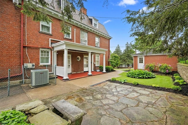 700 Meade St, Monongahela, PA 15063 - view of front of house featuring mansard roof, central AC, a high end roof, brick siding, and covered porch