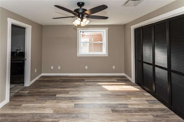 200 Centerwood Cir, South Union Twp, PA 15401 - unfurnished bedroom with wood finished floors, a closet, baseboards, and a ceiling fan