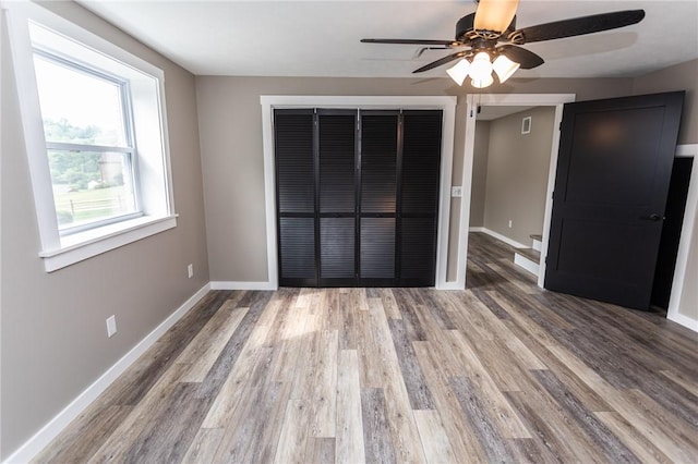 200 Centerwood Cir, South Union Twp, PA 15401 - unfurnished bedroom featuring a closet, baseboards, wood finished floors, and a ceiling fan