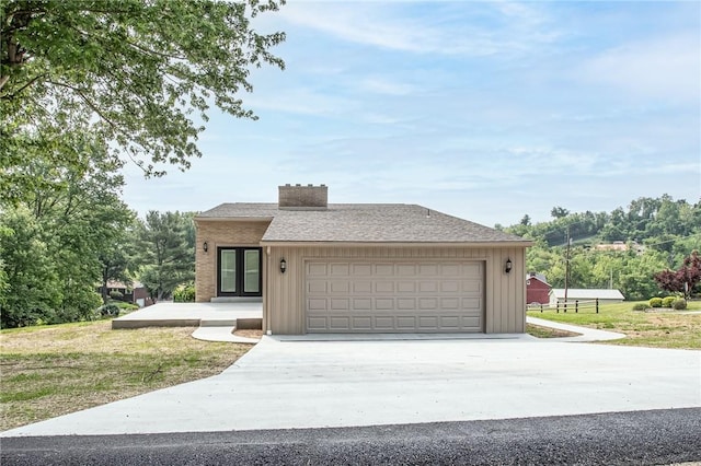 200 Centerwood Cir, South Union Twp, PA 15401 - view of front of property with concrete driveway, a garage, board and batten siding, a front yard, and a chimney