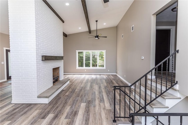 200 Centerwood Cir, South Union Twp, PA 15401 - unfurnished living room with a ceiling fan, wood finished floors, a brick fireplace, baseboards, and stairway