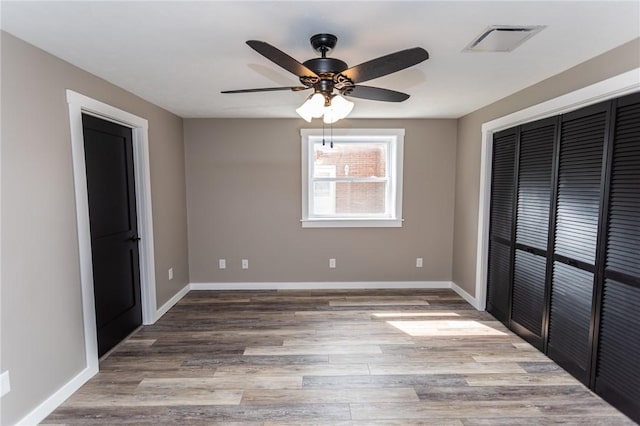 200 Centerwood Cir, South Union Twp, PA 15401 - unfurnished bedroom featuring baseboards, wood finished floors, a closet, and ceiling fan