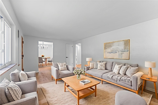 2396 Foster Rd, White Oak, PA 15131 - living area featuring light wood finished floors and a chandelier