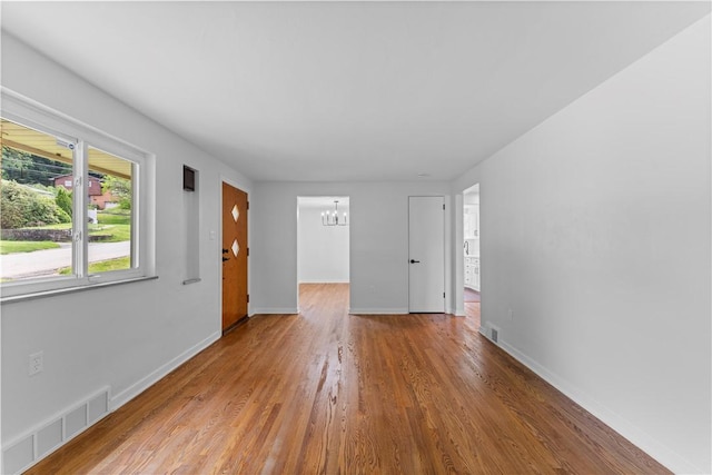 2396 Foster Rd, White Oak, PA 15131 - spare room with a chandelier, wood finished floors, and baseboards