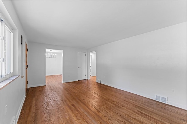 2396 Foster Rd, White Oak, PA 15131 - empty room featuring a chandelier, wood finished floors, and baseboards