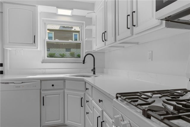2396 Foster Rd, White Oak, PA 15131 - kitchen with white dishwasher, a sink, white cabinets, light countertops, and range