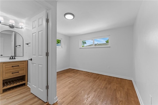 2396 Foster Rd, White Oak, PA 15131 - unfurnished bedroom featuring light wood-style flooring, baseboards, and a sink