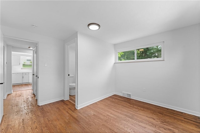2396 Foster Rd, White Oak, PA 15131 - unfurnished bedroom featuring light wood finished floors, multiple windows, and baseboards