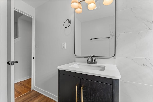 2396 Foster Rd, White Oak, PA 15131 - bathroom featuring vanity, wood finished floors, baseboards, and a chandelier