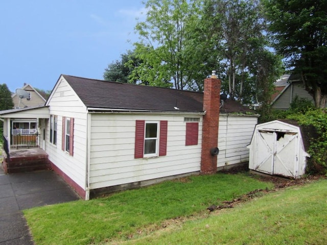 945 Roup Ave, Brackenridge, PA 15014 - view of side of property featuring a chimney, a lawn, and roof with shingles