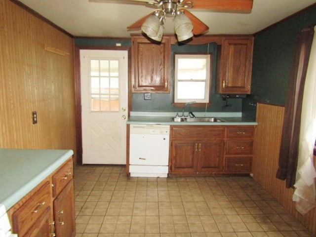 945 Roup Ave, Brackenridge, PA 15014 - kitchen with dishwasher, ceiling fan, a sink, light countertops, and wooden walls