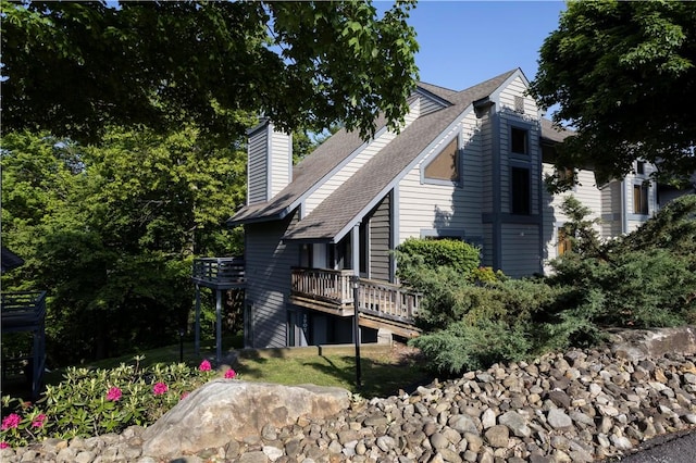 3908 Swiss Mountain Dr, Seven Springs Resort, PA 15622 - view of side of home with roof with shingles, a deck, and a chimney