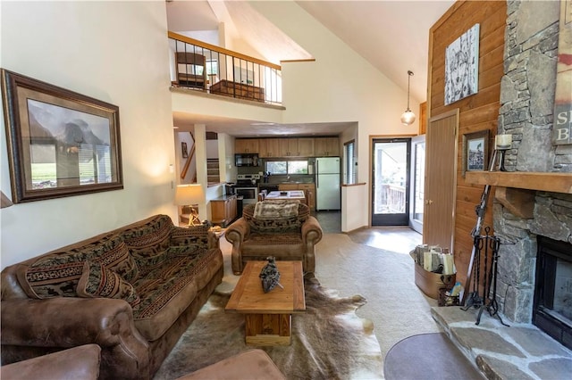 3908 Swiss Mountain Dr, Seven Springs Resort, PA 15622 - living area with high vaulted ceiling, light colored carpet, and a fireplace
