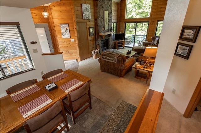 3908 Swiss Mountain Dr, Seven Springs Resort, PA 15622 - carpeted living area featuring wood walls, a towering ceiling, and a fireplace