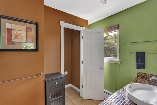 326 Pinevue Dr, Monroeville, PA 15146 - bathroom with a sink, baseboards, baseboard heating, and tile patterned flooring
