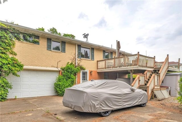 326 Pinevue Dr, Monroeville, PA 15146 - back of house with stairway, concrete driveway, a garage, brick siding, and a deck